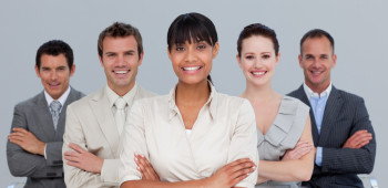 Smiling multi-ethnic business team with folded arms